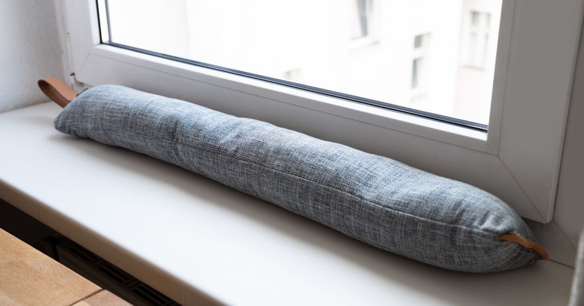 a long thin window cushion that prevents window drafts 